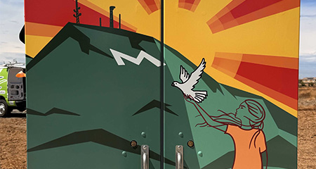 Utility box wrap of comic strip containg two humans and their pet dog.
