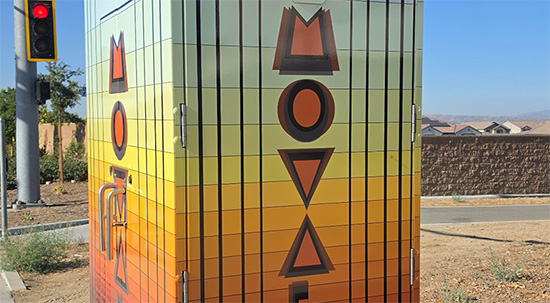 Utility box wrap with word MoVal vertically layed out. 